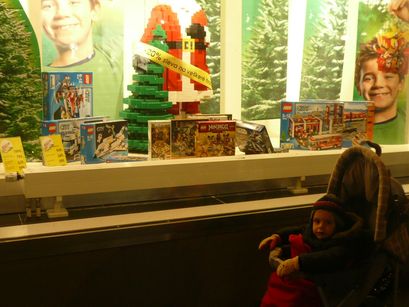 A boy in front of a toy store. Does life get any better than this? 
