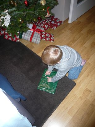 Unwrapping the first present. 