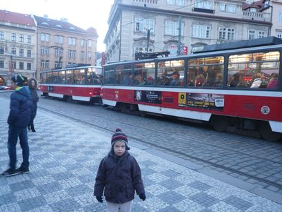 In front of a modern tram. 