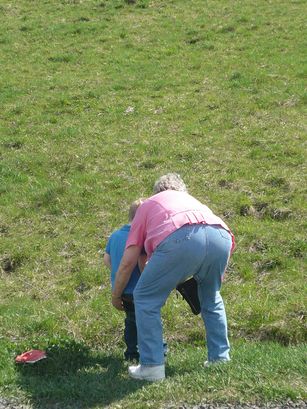 Grandma helping Ian "water the grass."